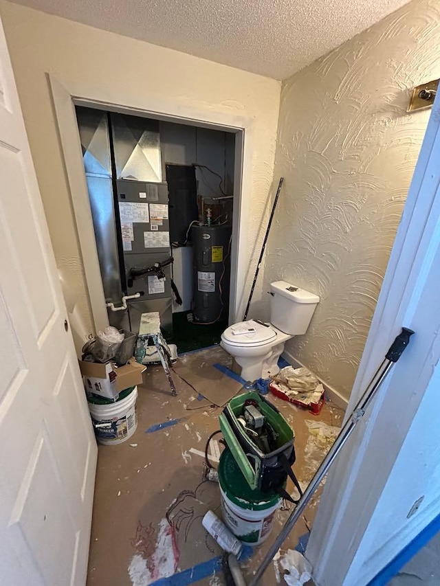 117 N Vermilion St, Potomac, IL 61865 - bathroom featuring water heater, a textured ceiling, toilet, and heating unit