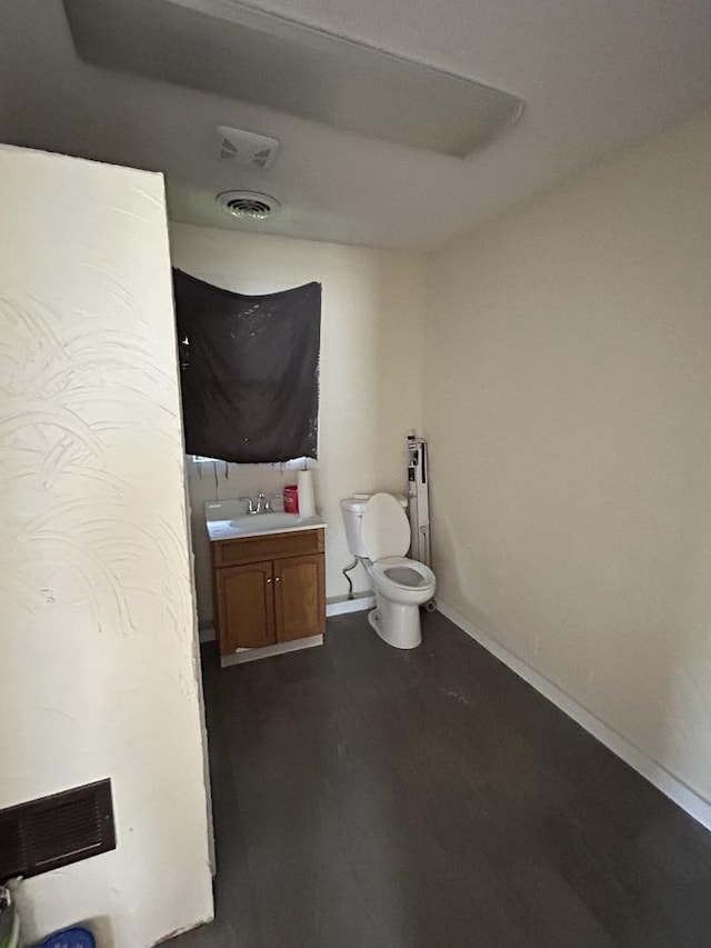 117 N Vermilion St, Potomac, IL 61865 - bathroom with toilet, vanity, baseboards, and wood finished floors