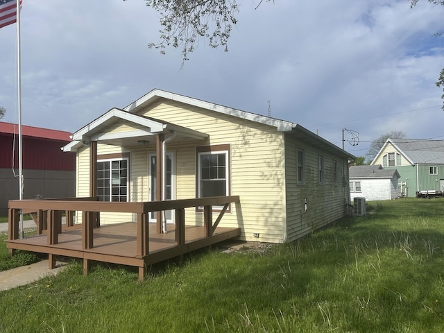 117 N Vermilion St, Potomac, IL 61865 - back of property with a wooden deck, cooling unit, and a yard