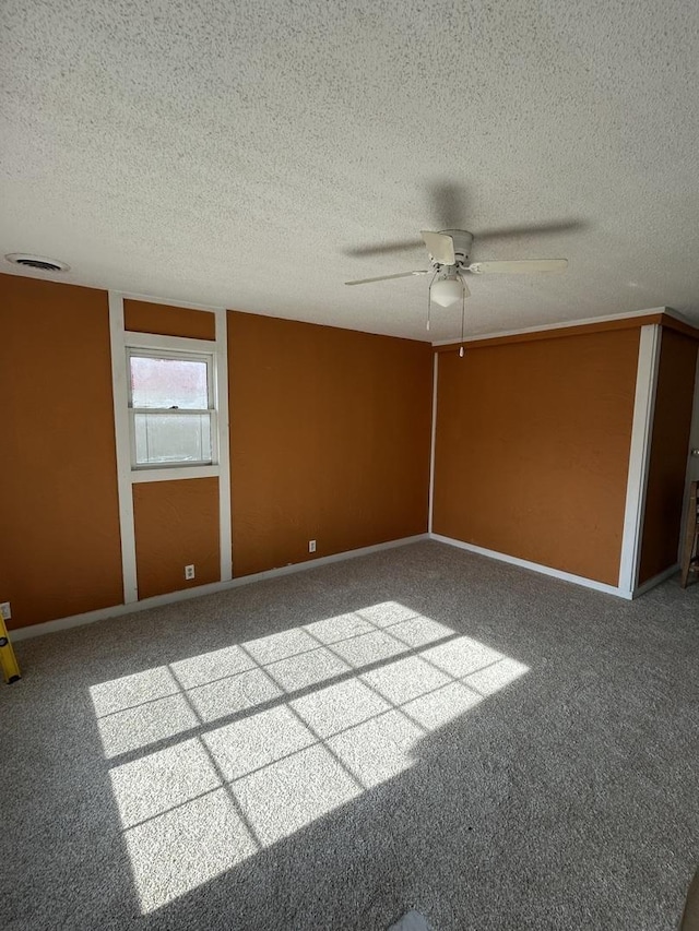 117 N Vermilion St, Potomac, IL 61865 - spare room featuring ceiling fan, carpet floors, a textured ceiling, and baseboards