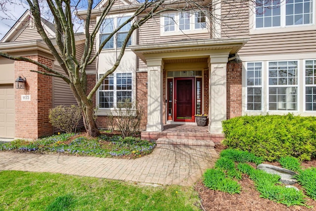 entrance to property featuring brick siding