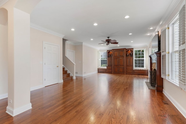 unfurnished living room featuring baseboards, wood finished floors, ceiling fan, and a fireplace