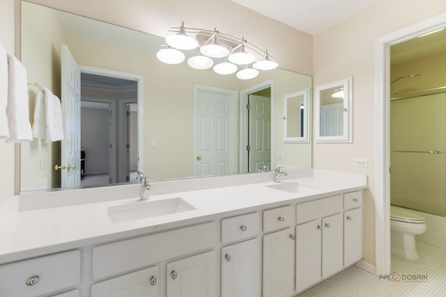 full bath with double vanity, toilet, and a sink