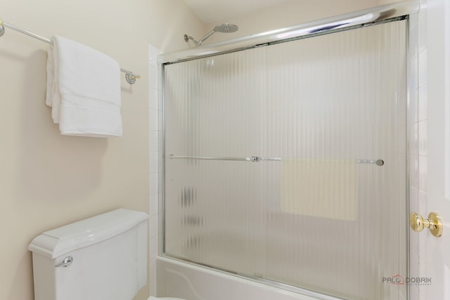 full bathroom featuring enclosed tub / shower combo and toilet