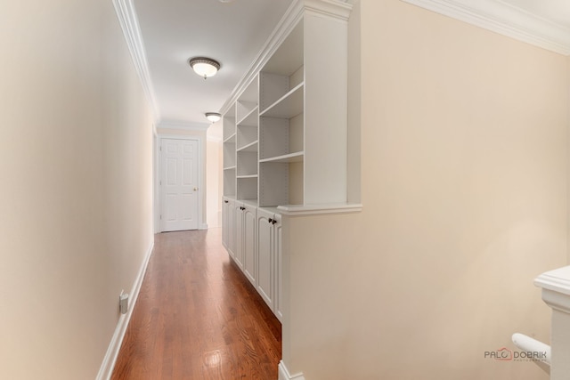 corridor with ornamental molding, wood finished floors, and baseboards