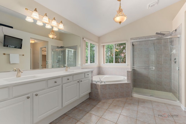 full bathroom with a garden tub, a stall shower, a sink, and tile patterned floors