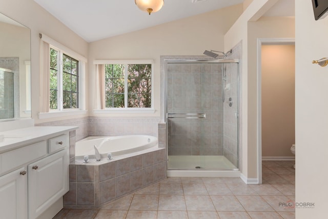 bathroom featuring a stall shower, tile patterned flooring, and vaulted ceiling