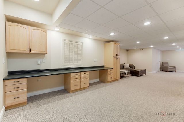 home office featuring light colored carpet, recessed lighting, built in desk, and baseboards