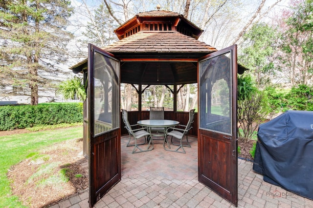 view of patio / terrace with outdoor dining area, a gazebo, and grilling area