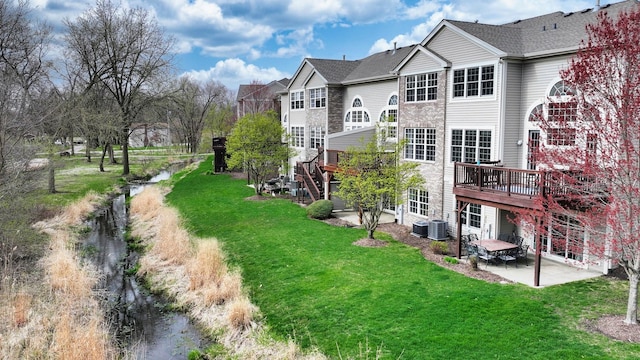 140 River Mist Dr, Oswego, IL 60543 - rear view of property with central AC, a lawn, a wooden deck, and a patio