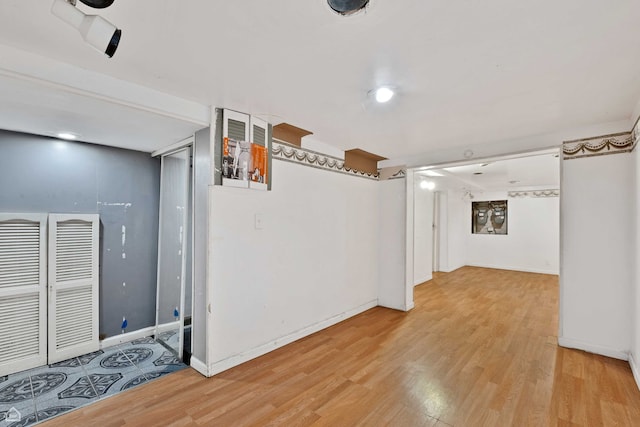finished below grade area featuring light wood-type flooring and baseboards