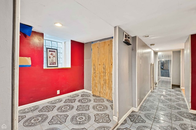 hallway featuring baseboards