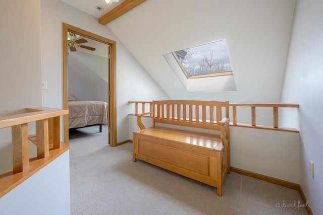 carpeted bedroom featuring baseboards and lofted ceiling with skylight