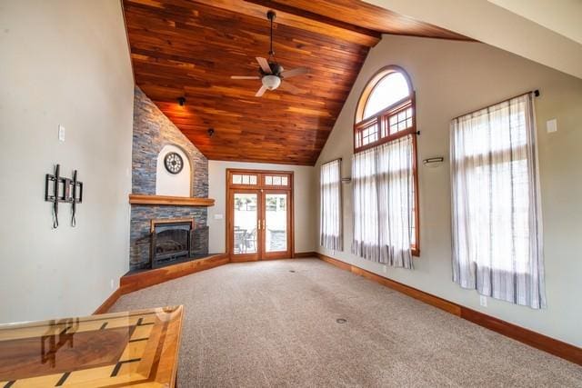 carpeted living room featuring a wealth of natural light, high vaulted ceiling, baseboards, and ceiling fan