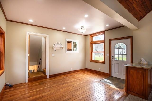 foyer entrance with crown molding, recessed lighting, stairs, light wood finished floors, and baseboards