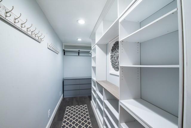 spacious closet with dark wood-style floors