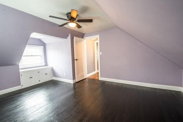 additional living space featuring baseboards, a ceiling fan, wood finished floors, and lofted ceiling