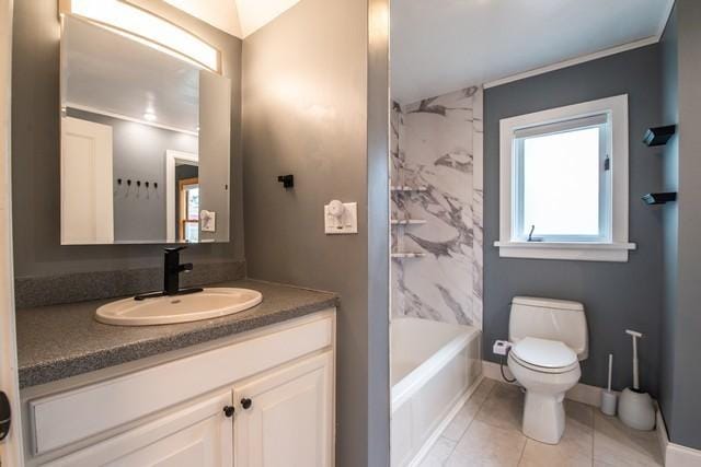 bathroom with toilet, tile patterned floors, vanity, and baseboards