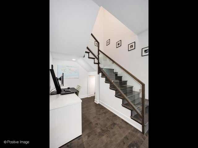 staircase with wood finished floors, baseboards, and recessed lighting