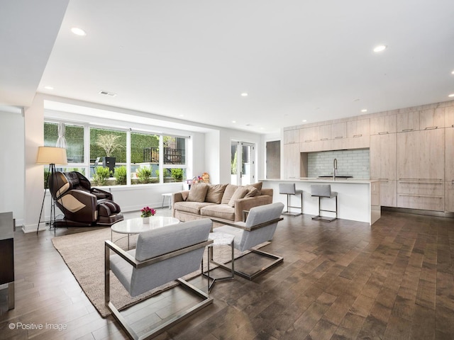 living area featuring dark wood finished floors, visible vents, and recessed lighting
