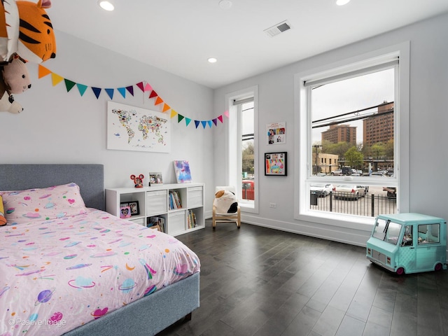 bedroom with dark wood-style flooring, visible vents, and recessed lighting
