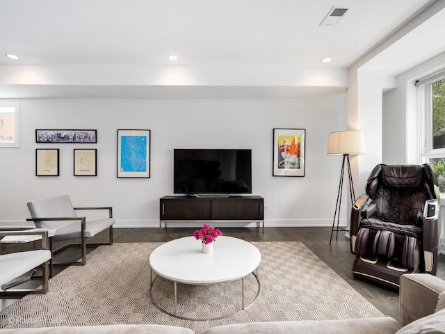 living area featuring visible vents, baseboards, recessed lighting, and wood finished floors