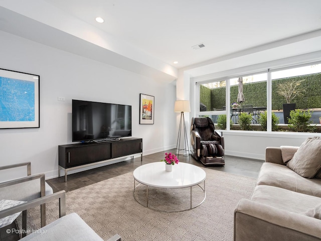 living area featuring recessed lighting, visible vents, baseboards, and wood finished floors