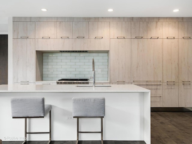 kitchen featuring a sink, recessed lighting, light brown cabinetry, and modern cabinets