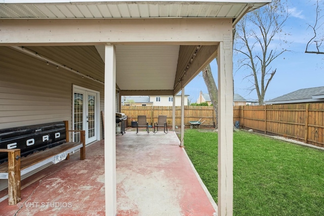 view of patio featuring grilling area, french doors, and fence