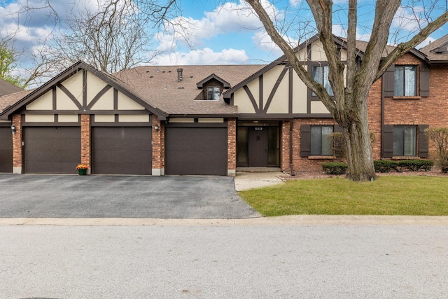 11212 Cottonwood Dr Unit 23A, Palos Hills, IL 60465 - english style home with stucco siding, roof with shingles, brick siding, a garage, and driveway