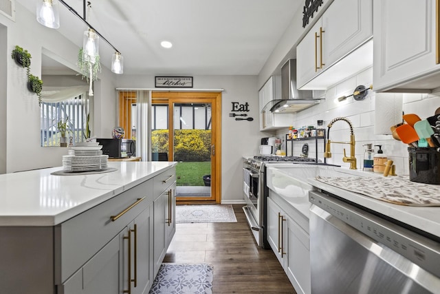 11212 Cottonwood Dr Unit 23A, Palos Hills, IL 60465 - kitchen with dark wood-style flooring, backsplash, gray cabinetry, wall chimney exhaust hood, and dishwasher