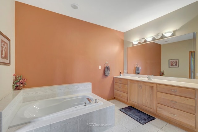 full bathroom with tile patterned flooring, a bath, and vanity