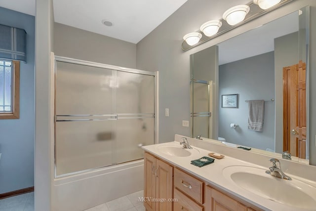 bathroom with tile patterned floors, double vanity, and a sink