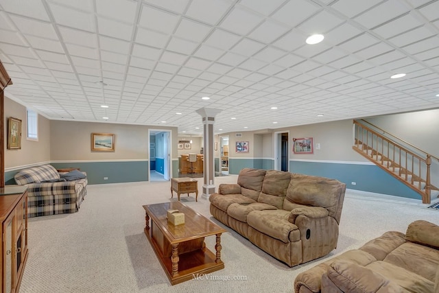 living area featuring baseboards, recessed lighting, stairway, carpet floors, and decorative columns