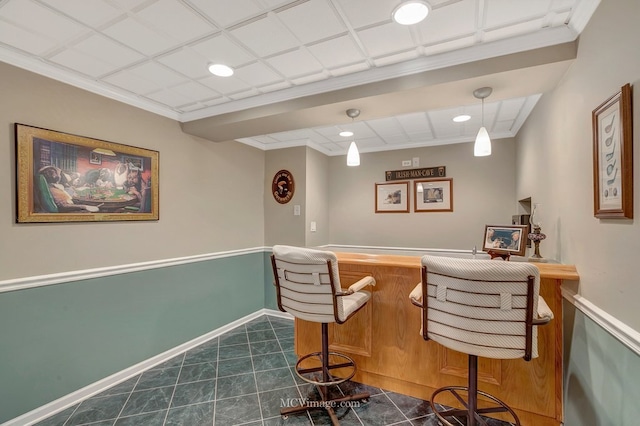 bar with dark tile patterned flooring, a dry bar, baseboards, and pendant lighting