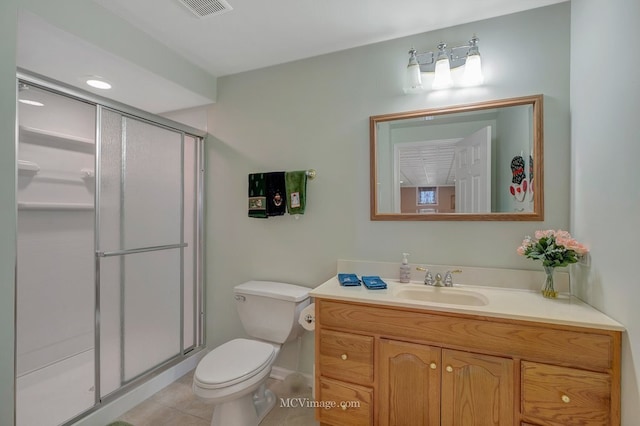 bathroom featuring visible vents, toilet, vanity, tile patterned floors, and a stall shower