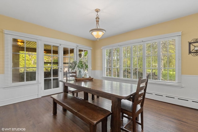 1046 N Hainesville Rd, Round Lake Beach, IL 60073 - dining area with plenty of natural light, wood finished floors, a wainscoted wall, and a baseboard heating unit