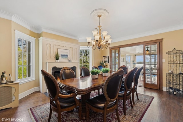 1046 N Hainesville Rd, Round Lake Beach, IL 60073 - dining space with a chandelier, ornamental molding, baseboards, and dark wood-style floors