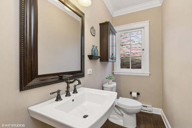 1046 N Hainesville Rd, Round Lake Beach, IL 60073 - half bath with a sink, crown molding, toilet, baseboards, and wood finished floors