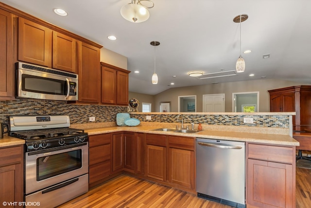 1046 N Hainesville Rd, Round Lake Beach, IL 60073 - kitchen featuring appliances with stainless steel finishes, a sink, light wood-type flooring, backsplash, and light countertops