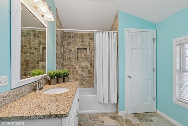 1046 N Hainesville Rd, Round Lake Beach, IL 60073 - full bath with shower / bath combo, vanity, vaulted ceiling, and baseboards