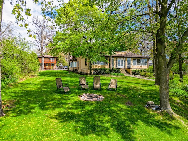 1046 N Hainesville Rd, Round Lake Beach, IL 60073 - view of grassy yard featuring an outdoor fire pit