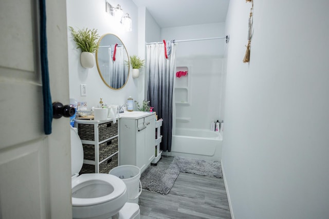 732 N Dearborn Ave, Kankakee, IL 60901 - bathroom with vanity, baseboards, toilet, shower / bathtub combination with curtain, and wood finished floors