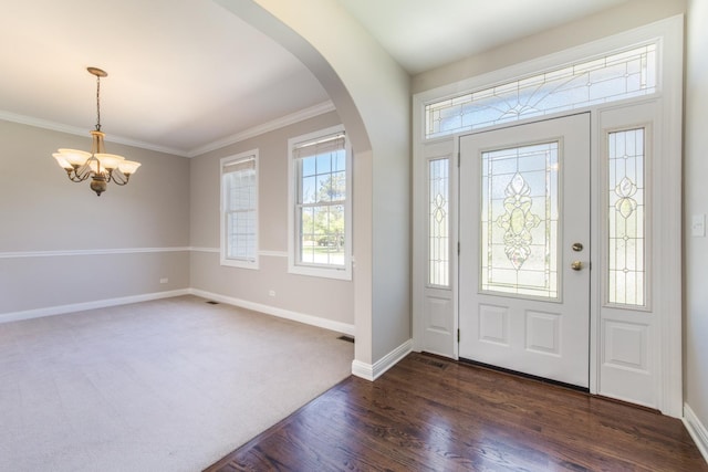 6433 Davidson Ct, Gurnee, IL 60031 - foyer entrance with a chandelier, arched walkways, baseboards, dark wood-style floors, and ornamental molding