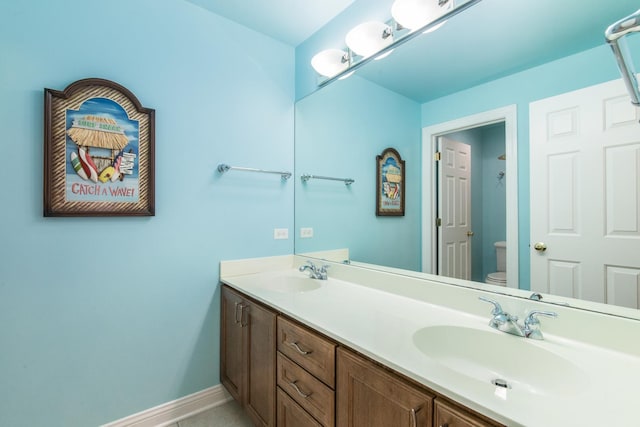 6433 Davidson Ct, Gurnee, IL 60031 - bathroom with toilet, double vanity, and baseboards