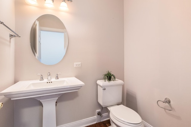 6433 Davidson Ct, Gurnee, IL 60031 - bathroom featuring baseboards, toilet, wood finished floors, and a sink