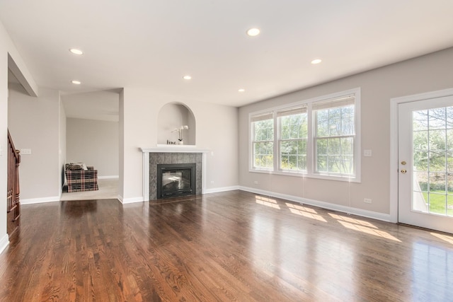 6433 Davidson Ct, Gurnee, IL 60031 - unfurnished living room with healthy amount of natural light, recessed lighting, a tiled fireplace, wood finished floors, and baseboards