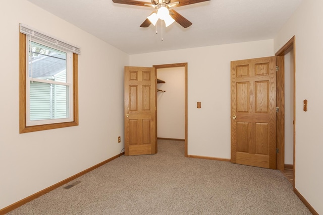 unfurnished bedroom with light carpet, visible vents, and baseboards