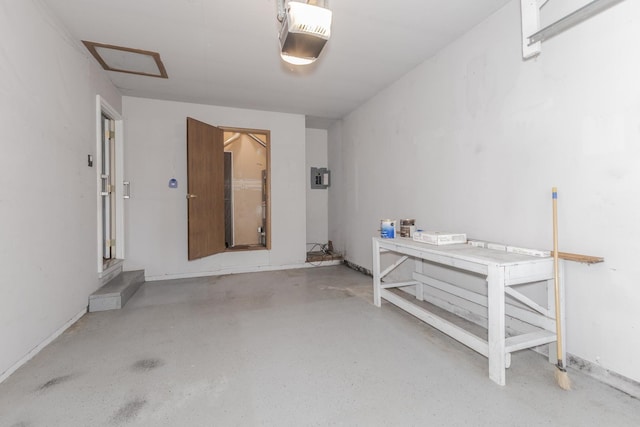 garage with baseboards and a garage door opener
