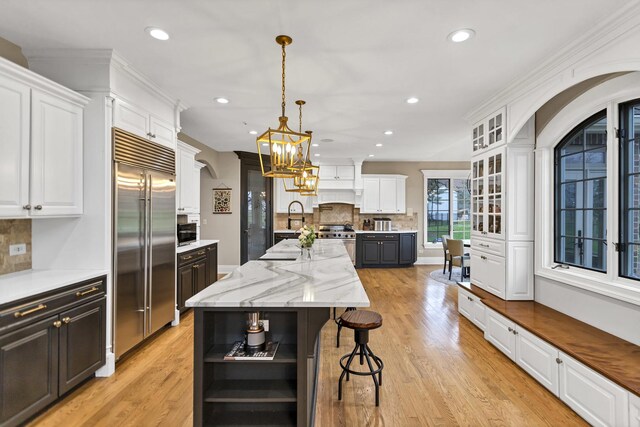 41W050 Stoneridge Ln, Elgin, IL 60124 - kitchen with white cabinetry, premium appliances, open shelves, and a center island